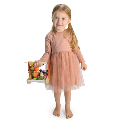 Young girl in a pink dress holding Tender Leaf Wild Wood Foraging Trug