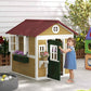 Girl Opening the Door of Outsunny Wooden Playhouse for Kids Beige