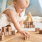 Baby Playing Tiny Land® Wooden Alphabet Blocks