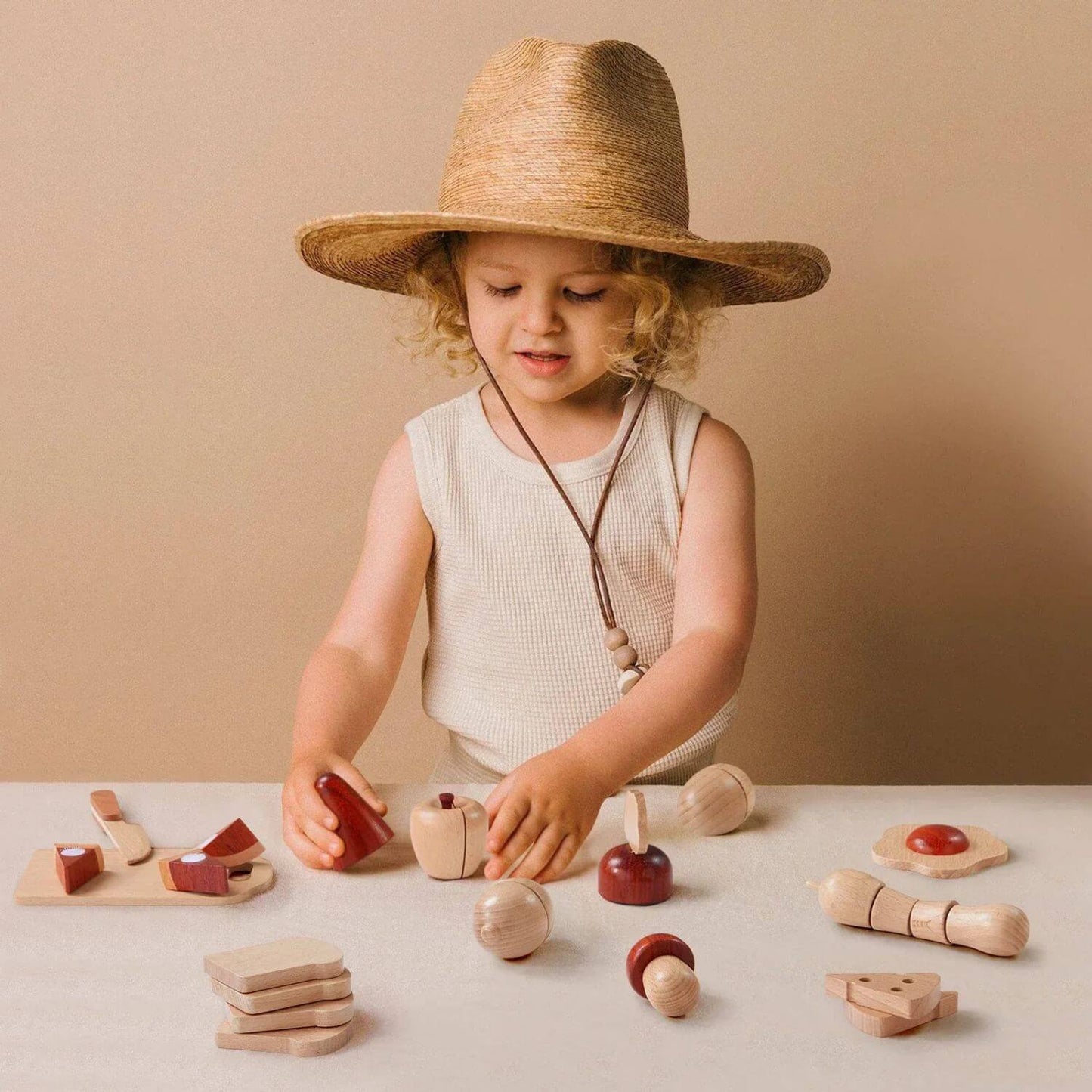 Girl Playing Tiny Land® Wooden Cut and Play Food Toys