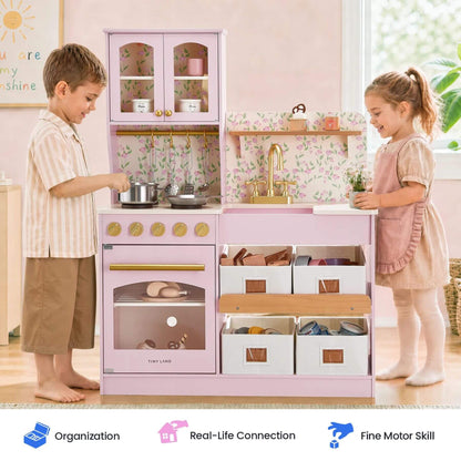 Tiny Land® Wooden Play Kitchen - Pink, shown with two children interacting in a bright room. Three feature badges appear along the bottom.