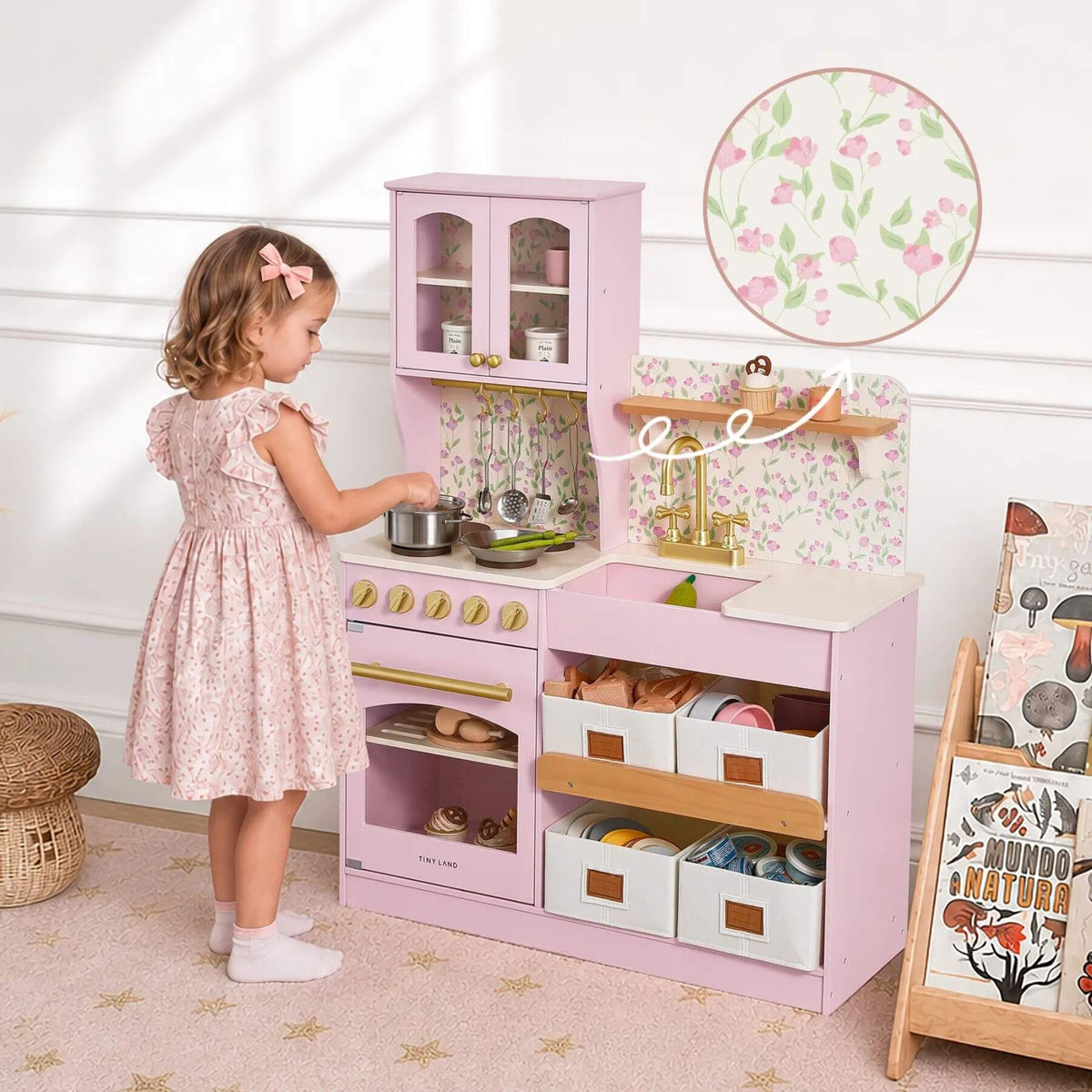 A young girl at Tiny Land® Wooden Play Kitchen - Pink, in a bright nursery setting.