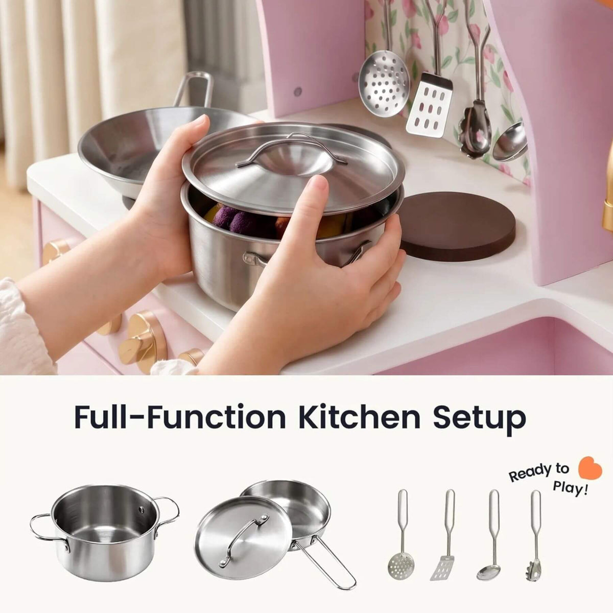 A child's hands are shown holding a stainless steel play kitchen pot and lid over a pink toy kitchen counter.