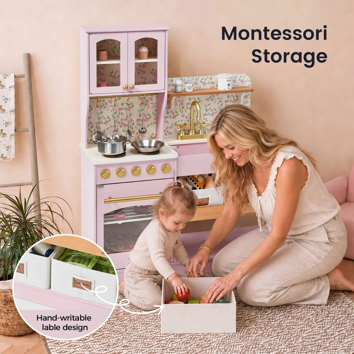 A woman and child are organizing toys in pastel pink Montessori storage boxes on a woven rug, with a matching pink play kitchen in the background.