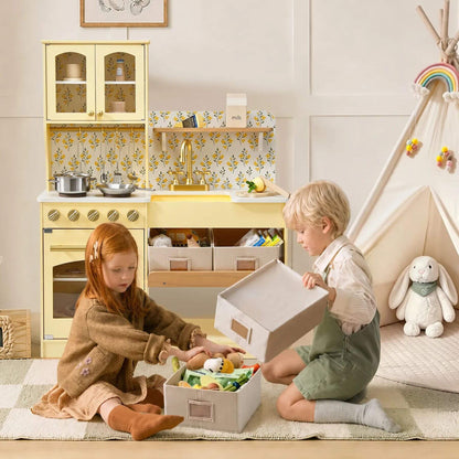 Two children playing with Tiny Land® Wooden Play Kitchen with Storage - Yellow in a bright nursery.