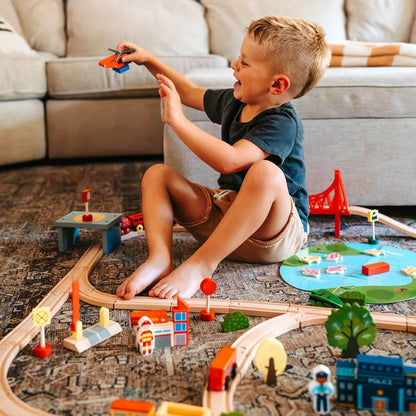 Boy Playing Tiny Land® Wooden Train Set 110 Pcs