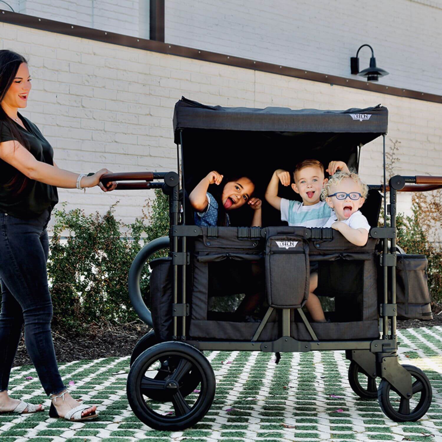 Mom Pushing Kids in Keenz XC+ - Luxury Comfort Stroller Wagon 4 Passenger Black