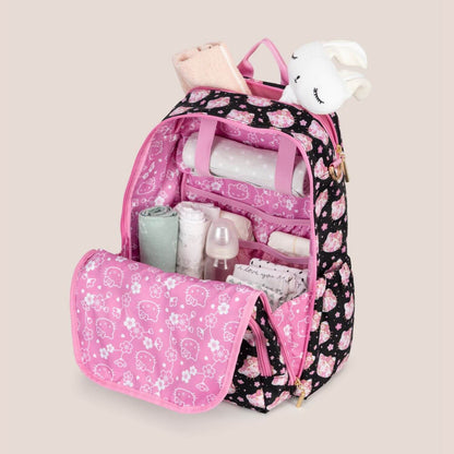 Cherry Blossoms Zealous Backpack with organized contents on a beige background