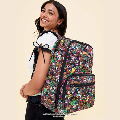 A smiling woman wearing tokidoki Zealous Backpack Diaper Bag – Dia de los Muertos