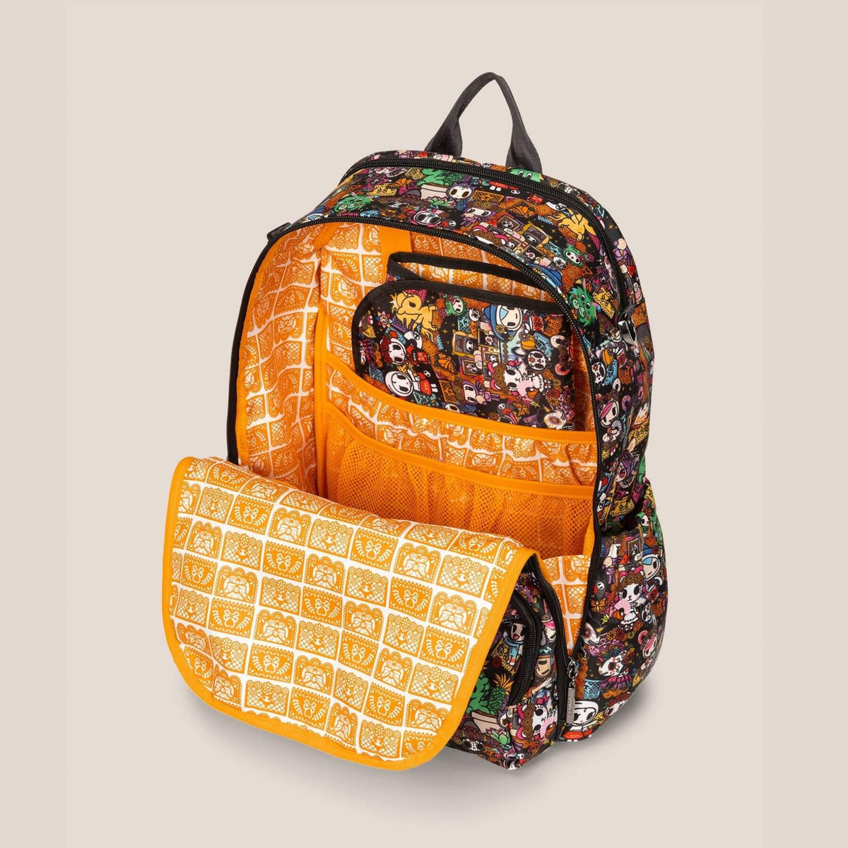 tokidoki Zealous Backpack Diaper Bag – Dia de los Muertos, shown open with a matching zippered pouch and a patterned flap resting in front, on a solid light beige background.