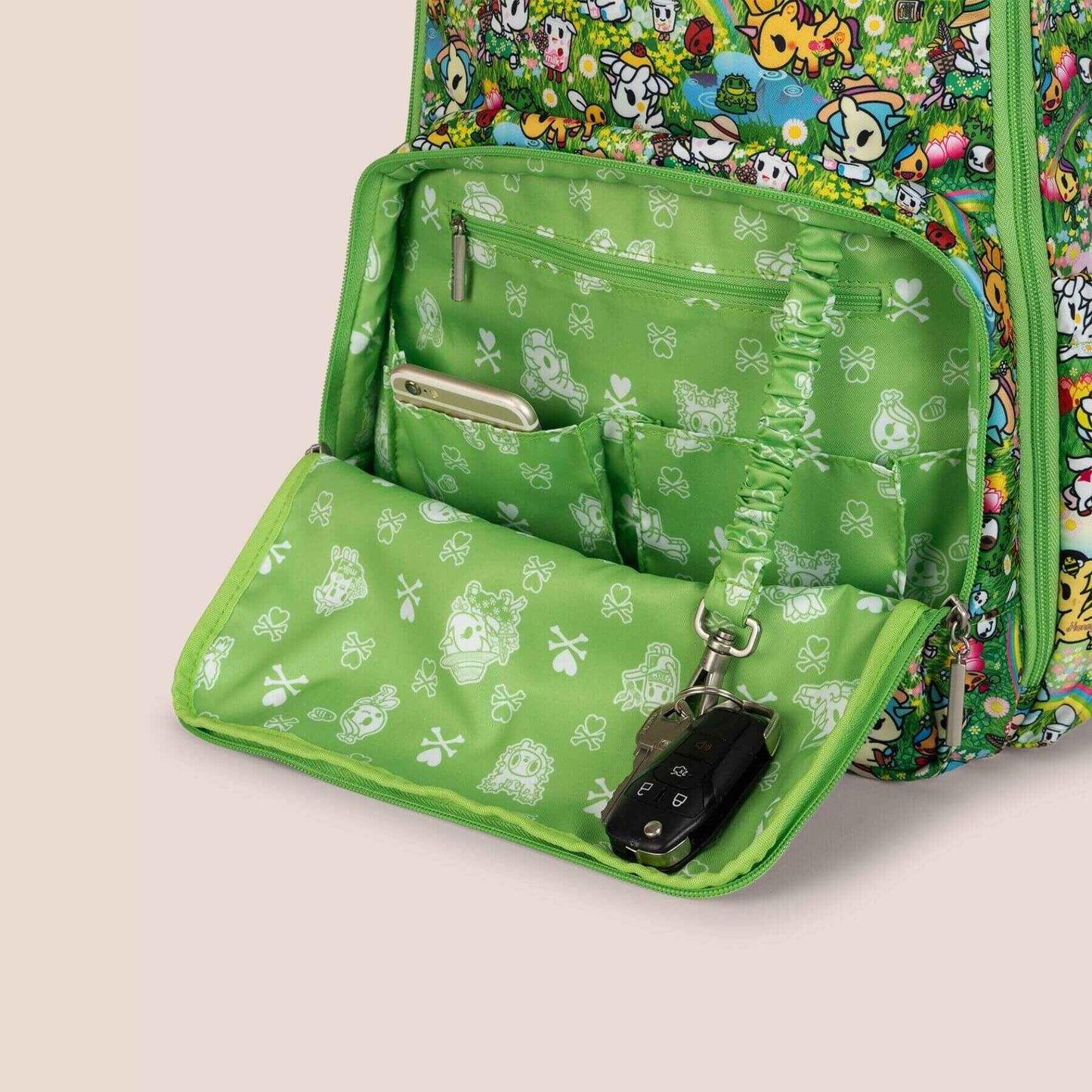 Green patterned bag with a keychain on a beige background