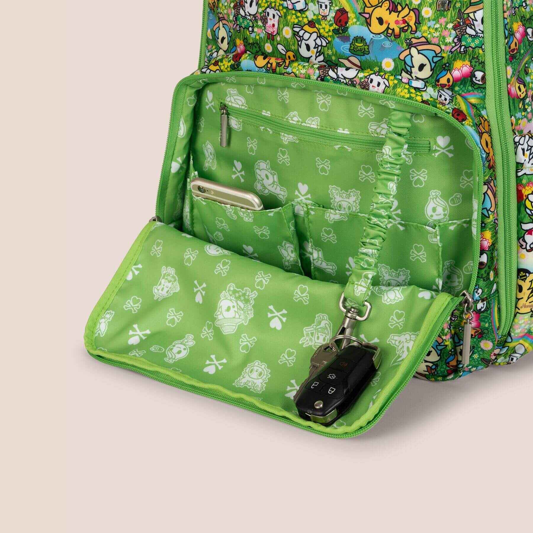Green patterned bag with a keychain on a beige background