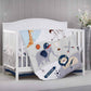 White crib with Zoo Sports 3 pc Baby Crib Nursery Bedding Set on a wooden floor.